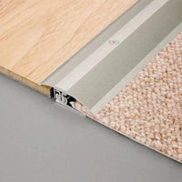 Transition between carpet and laminate flooring with installed multi-transition profile aluminium